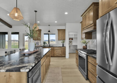 Vibrant and spacious kitchen with wood cabinetry and dark swirled countertops